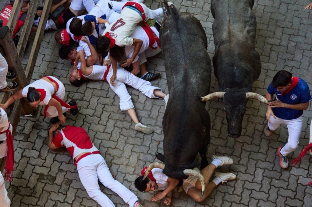 San Fermin bull run runners fleeing a charging bull in Pamplona