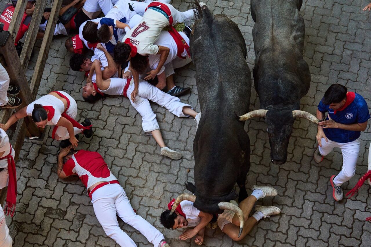 San Fermin bull run runners fleeing a charging bull in Pamplona